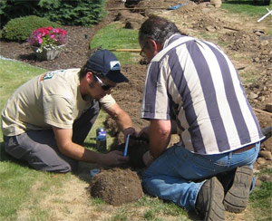 two of our Richmond sprinkler repair techs are fixing a broken system